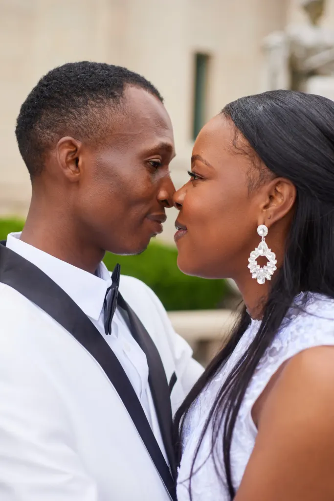 Bride and groom nose to nose, her drop earring catching the light