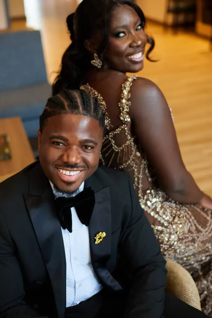 Groom seated in front, bride smiling over his shoulder