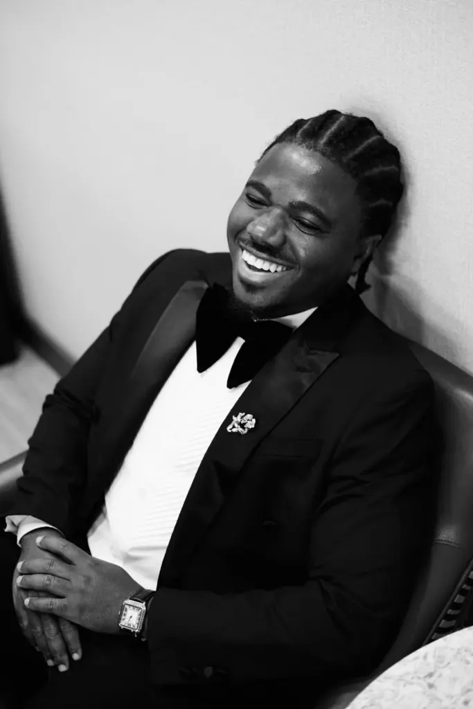 Black and white portrait of the groom laughing